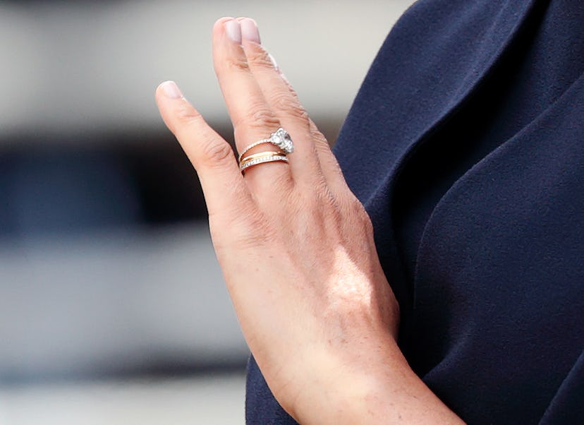 Meghan, Duchess of Sussex (ring detail) travels down The Mall in a horse drawn carriage during Troop...