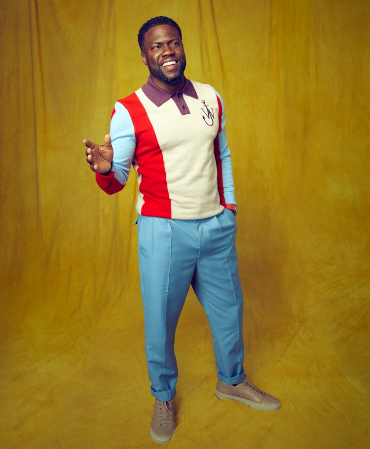 Kevin Hart wears a red, blue, and yellow JW Anderson sweater while posing for Romper's Father's Day ...