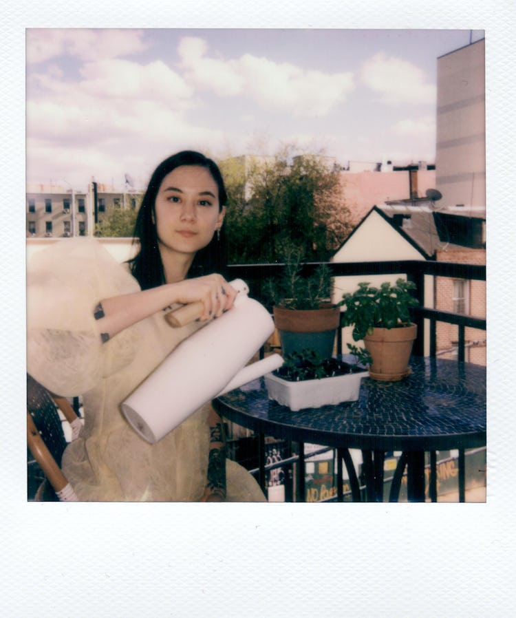 Michelle Zauner on her balcony pouring water over the fruit.