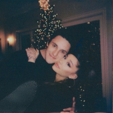 Dalton and Ariana hugging in front of a Christmas tree