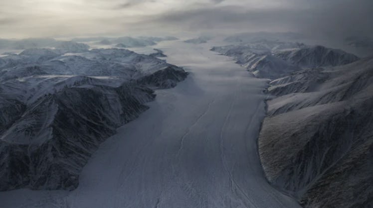 A section of a glacier is seen from NASA's Operation IceBridge research aircraft. Arctic sea ice lev...
