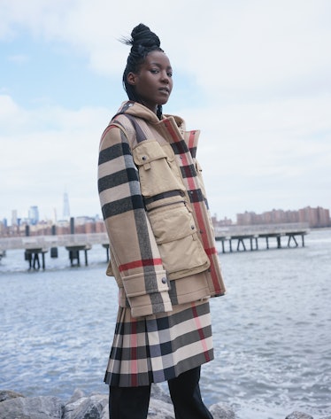 Hawa wears a Burberry coat with detachable vest, skirt, and pants.