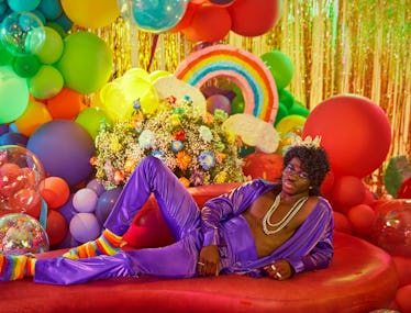 lil nas x reclining in a purple outfit