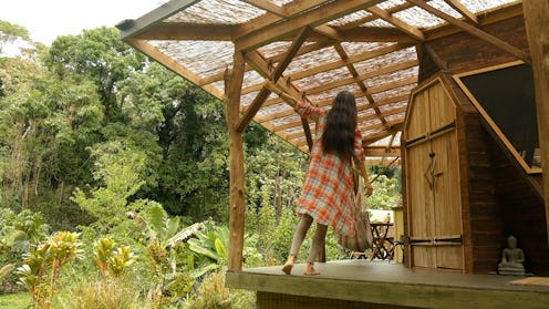 A girl enjoying her day on a terrace of a Hawaii wooden house