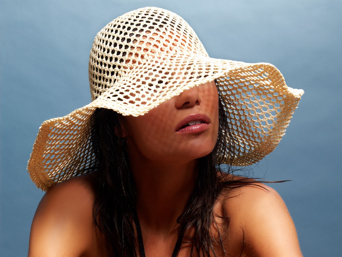Tan woman in sun hat