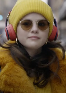 Selena Gomez wearing a yellow beanie and teddy coat