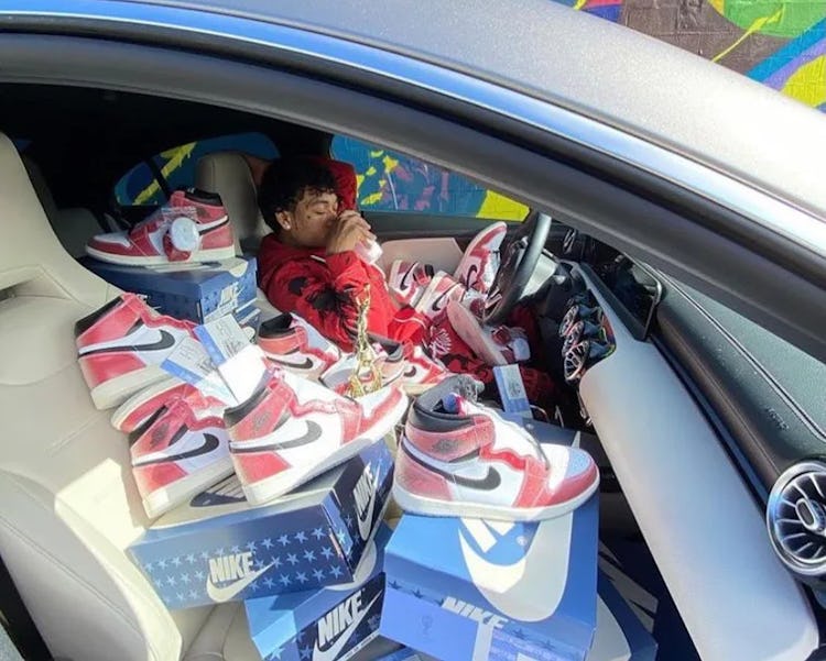 Sneaker reseller posing with Nike's Air Jordan 1 x Trophy Room "Freeze Out" sneaker