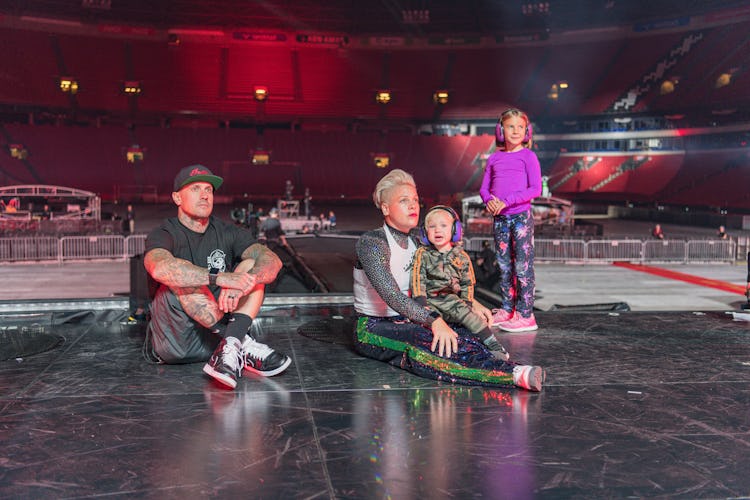 Pink with her family sitting on stage in empty theater