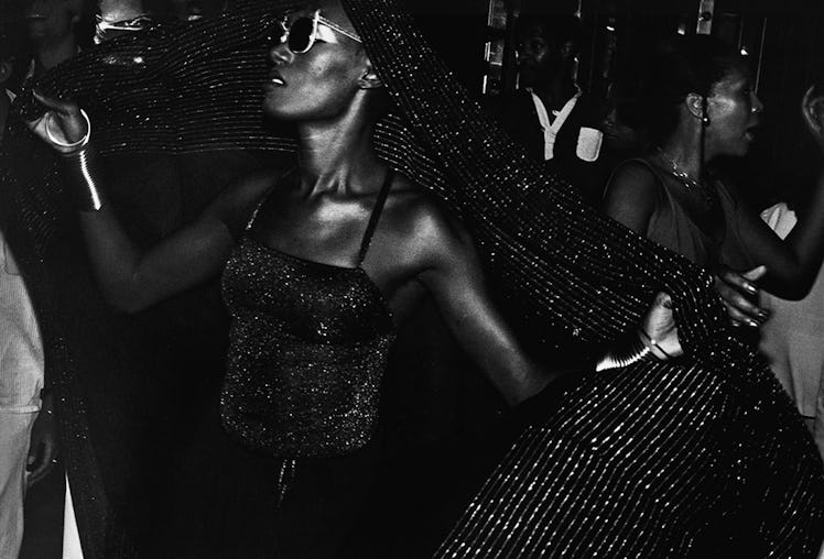 Grace Jones in a black shimmery tank top dancing at Studio 54