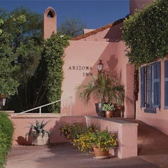 Front of Arizona Inn, a historic boutique hotel retreat that's painted pink.