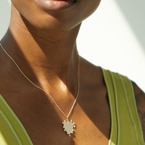 Model wears Heart Charm Necklace from the Catbird x The RealReal colleciton.
