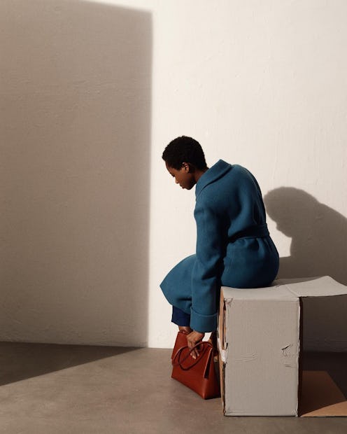 Model carrying a Yvonne Koné handbag.