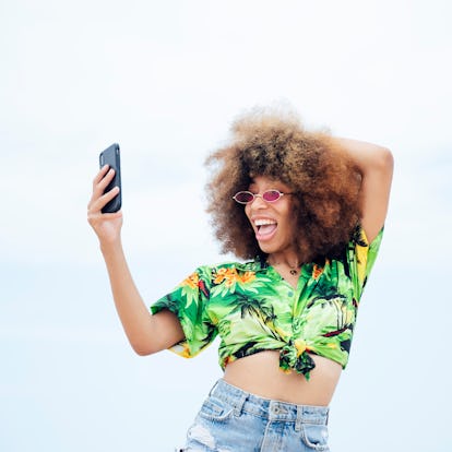 Young woman making a funny face while looking at the funniest Reverse Shapeshifting effect TikToks o...