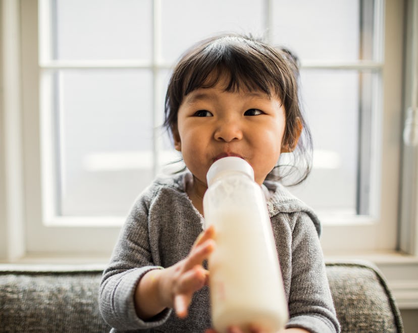 2-year-old toddler drinking milk from a bottle