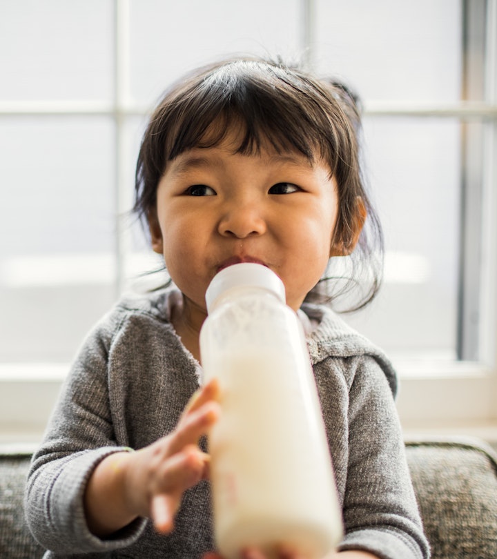 2-year-old toddler drinking milk from a bottle