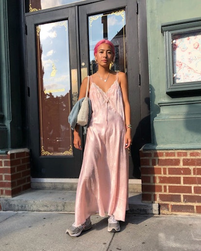 Michelle Li wears a light pink slip dress paired with chunky sneakers.