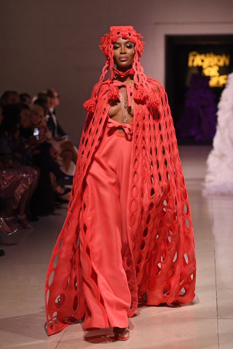 Naomi Campbell wearing red on the runway