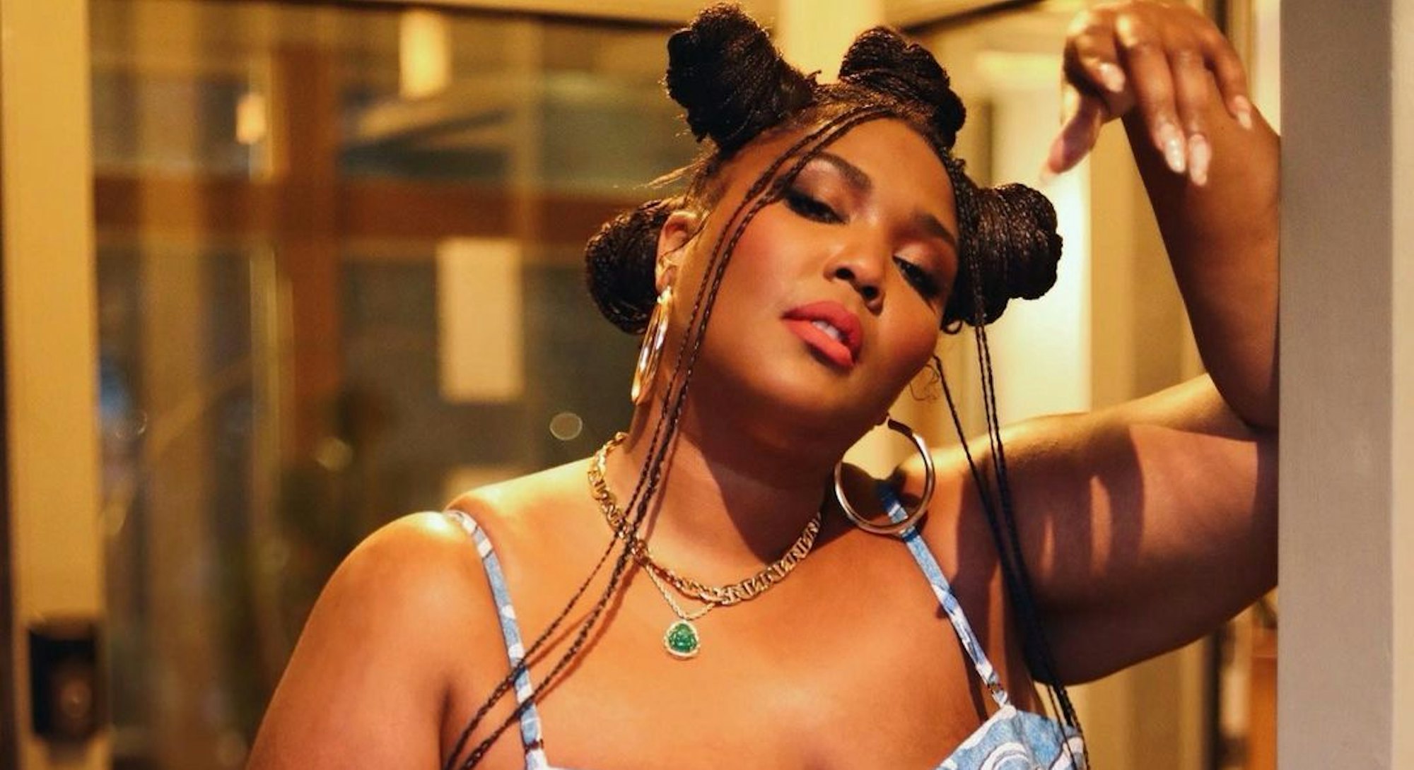 Lizzo is one of the Best Dressed Celebrities this week. Here, she rocks a matching crop top and skir...