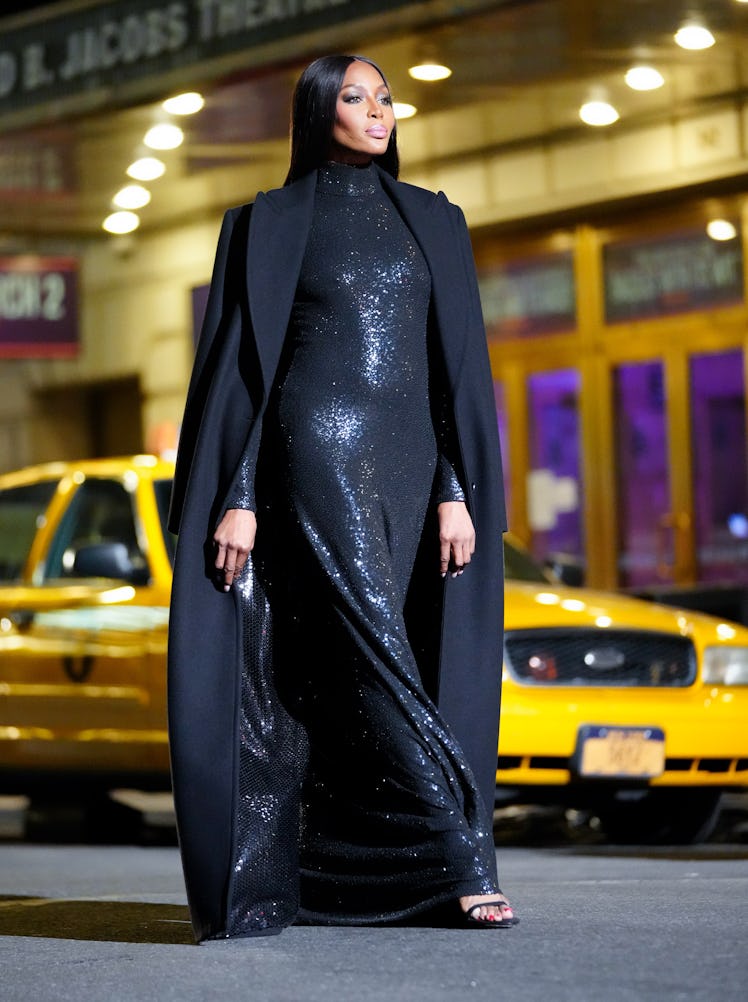 Naomi Campbell walking Michael Kors in a cape