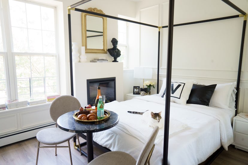 A bedroom with fruit and drinks on the bedside table decorated with two different aesthetics merged