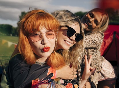 3 young women smiling, laughing and using quotes on the last day of school for Instagram captions.