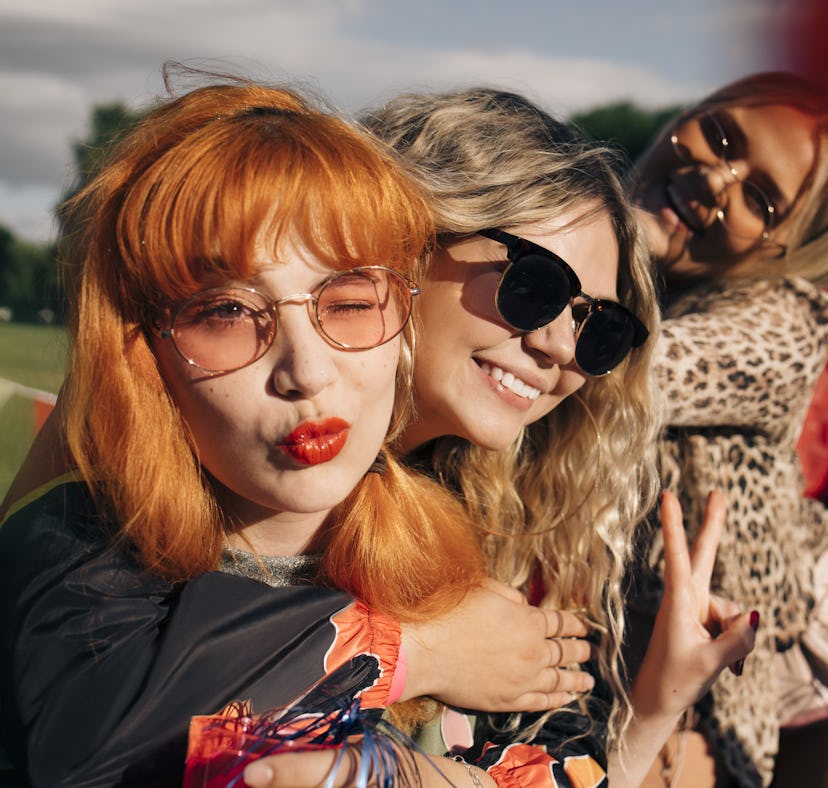 3 young women smiling, laughing and using quotes on the last day of school for Instagram captions.
