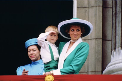 Diana, Princess of Wales, holding a young Prince Harry in matching emerald green