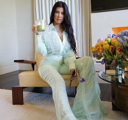 Kourtney Kardashian wears a green Salvatore Ferragamo suit.