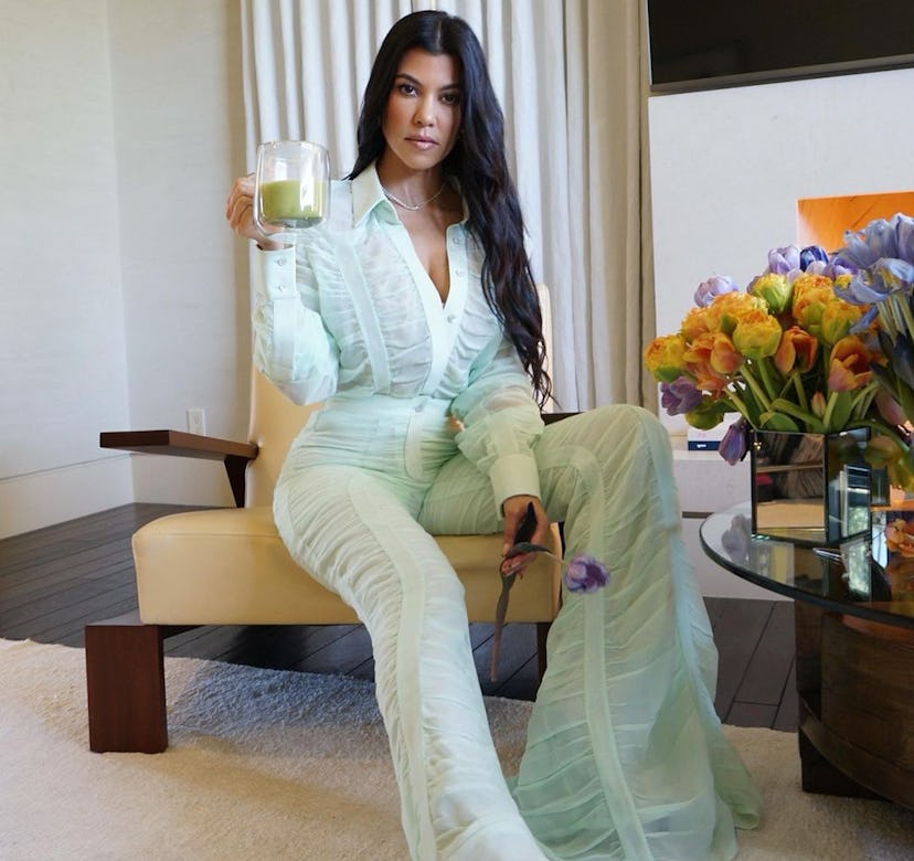 Kourtney Kardashian wears a green Salvatore Ferragamo suit.
