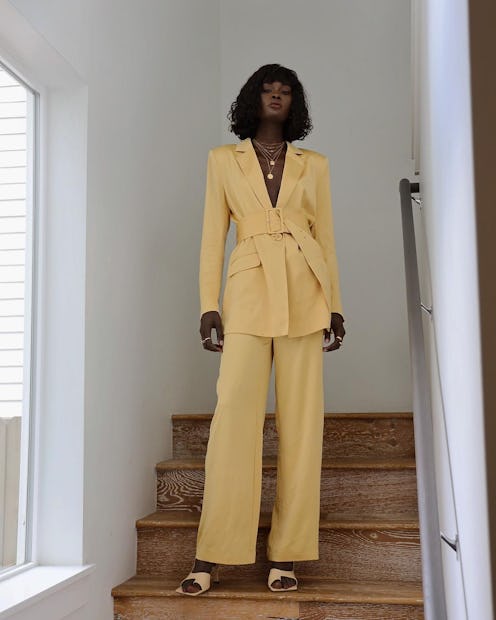 Model Amy Julliette Lefévre wears a yellow pantsuit.