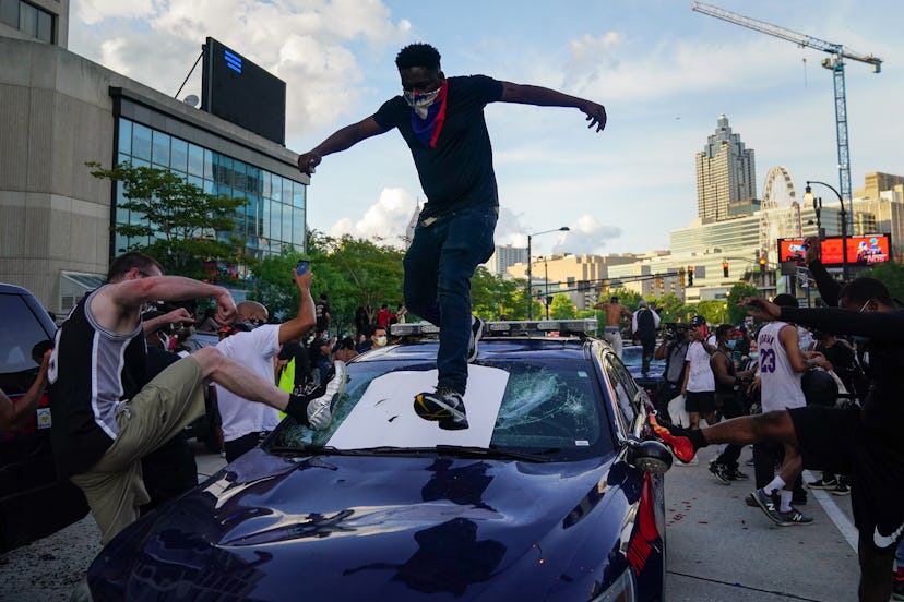 Protesters smashing a police car in Atlanta