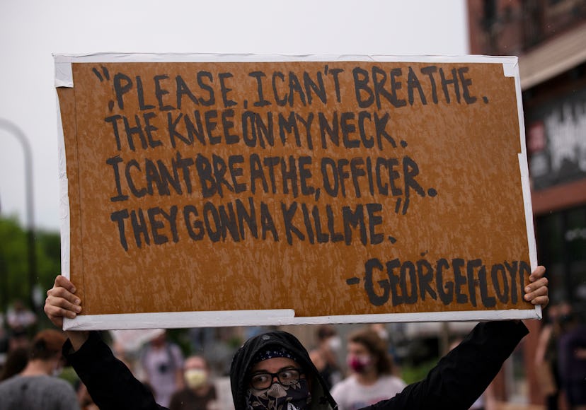 A protester in Minneapolis holding a sign, depicting Floyd's last words 