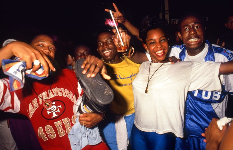 A group of people posing and smiling at the Fridge, London, 1989.