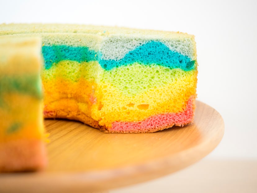 One layer of chiffon cake with rainbow coloring; sitting on wood cake stand