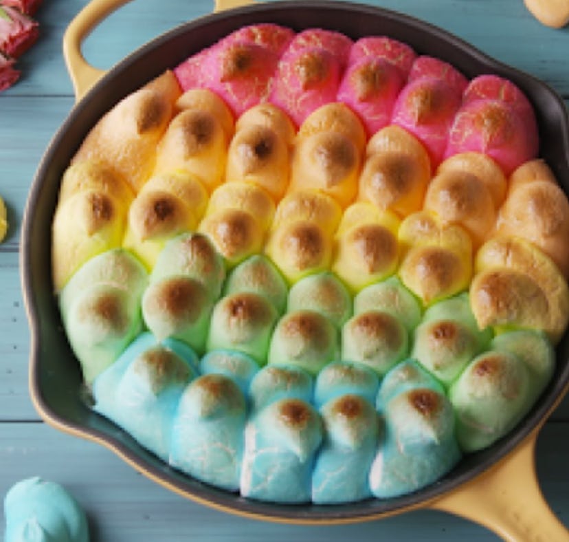 Iron skilled full of Peeps marshmallows in various colors, lightly toasted into a dip