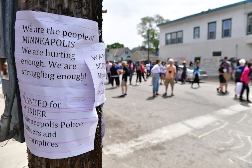 Signs stapled to a light pole in Minneapolis that depict the struggles and pain of the people of Min...