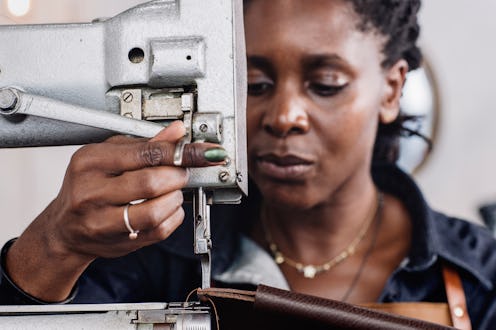A woman at a sewing machine.