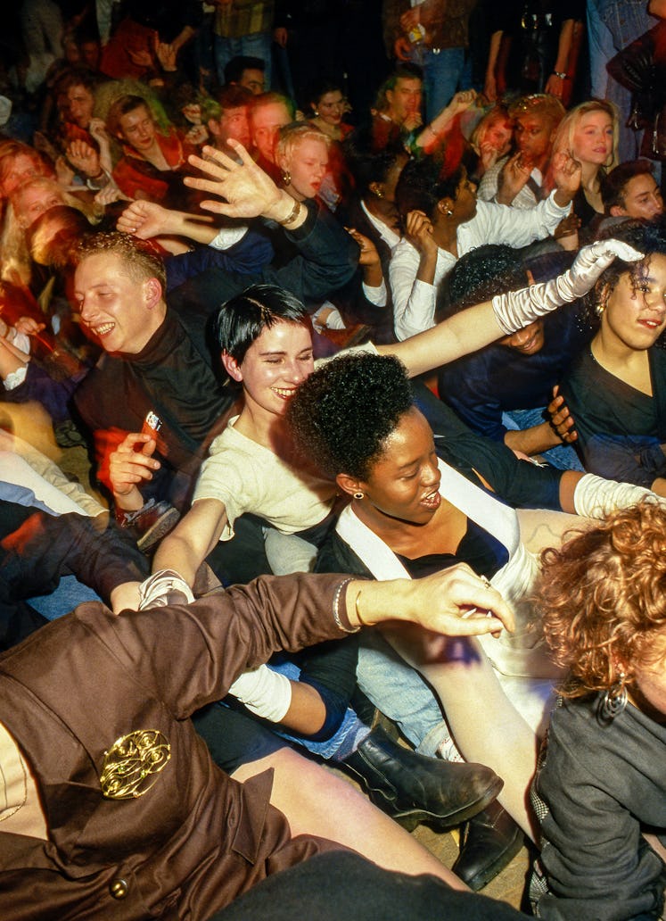 A crowd dancing and smiling at Discotheque, London, 1988.