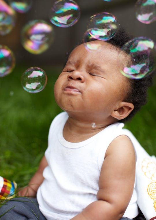 baby playing with bubbles