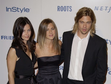Courtney Cox, Jennifer Aniston and Brad Pitt posing at a red carpet event