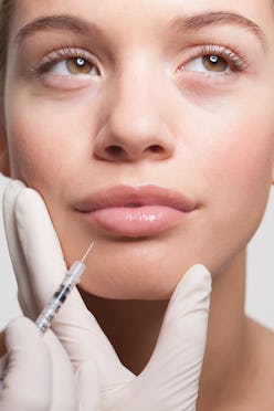 Woman receiving lip injections