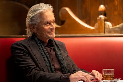A photo of Michael Douglas as Sandy Kominsky sitting in a booth with a drink in front of him