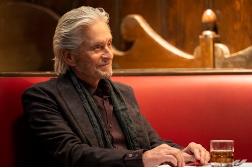 A photo of Michael Douglas as Sandy Kominsky sitting in a booth with a drink in front of him