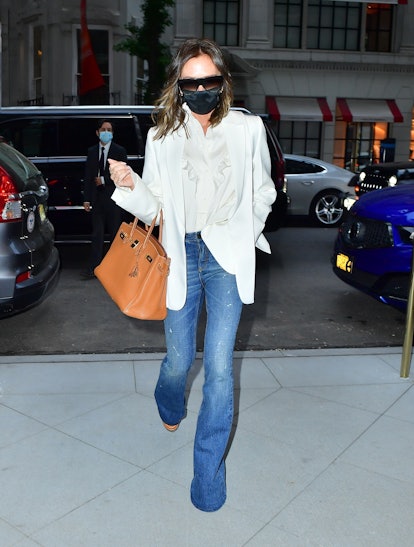 Victoria Beckham wears flared blue jeans while out in New York City.