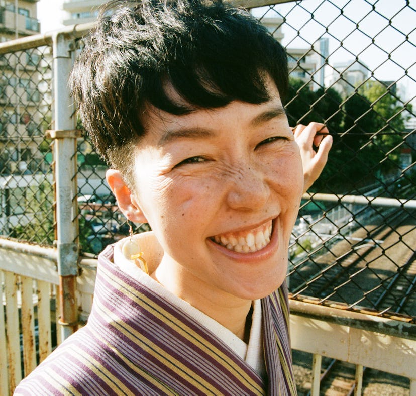 Young femme smiling, celebrating the best day in June 2021 for every zodiac sign.