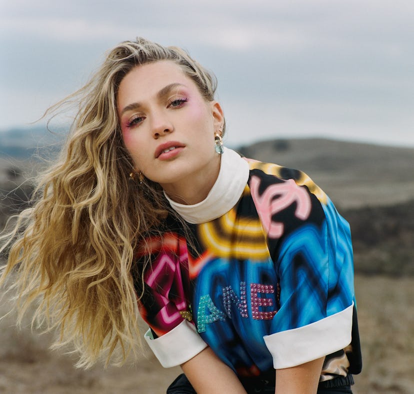 Maddie Ziegler posing in a landscape wearing bold-printed Chanel clothing for Elite Daily's BFF Issu...