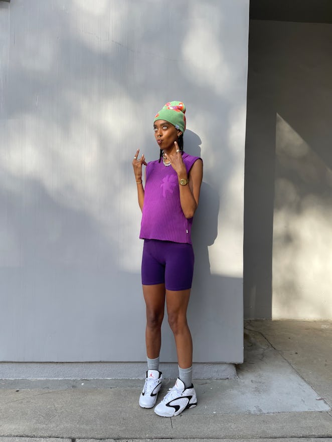 Briana King posing in white Air Jordan sneakers, dark blue bicycle shorts, and a light purple Heaven...