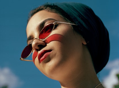 Young woman with red sunglasses during the week of May 31, 2021, waiting for her weekly horoscope.