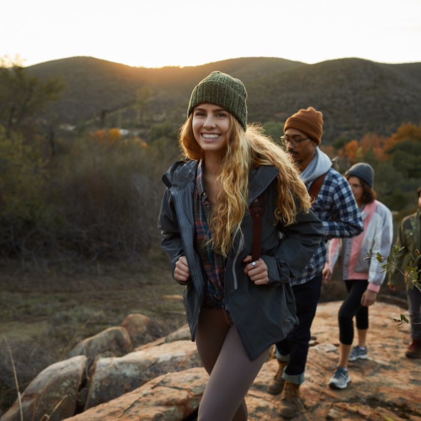 Young woman hiking with friends, preparing hiking captions, hiking instagram captions, and mountain ...