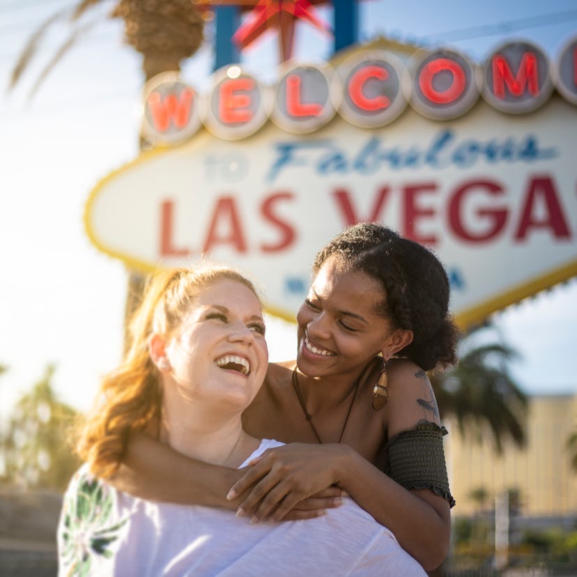 2 friends posing in front of the Las Vegas welcome sign.